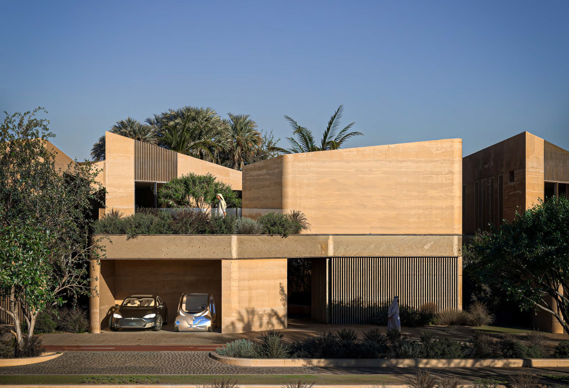 The street elevation under palms, with the carport recessed below